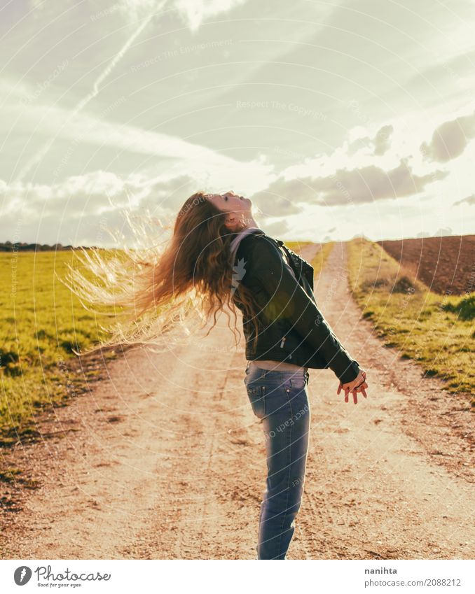 Young woman enjoying the sunset with wind blowing her hair - a Royalty Free  Stock Photo from Photocase