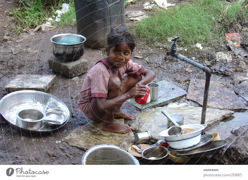 Life in the slum Slum area Sordid Child Girl Playing Poverty Dirty Earth