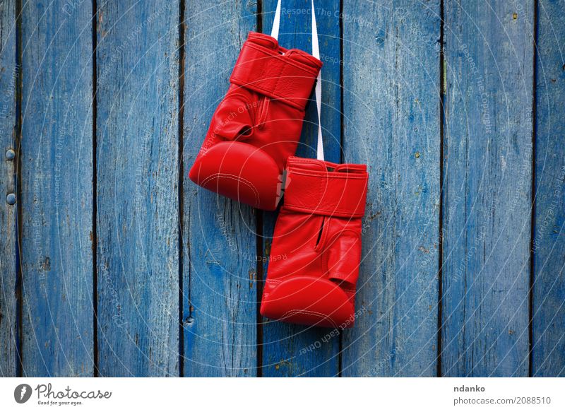 pair of red gloves for kickboxing Sports Success Rope Leather Gloves Wood Old Dirty Retro Blue Red Competition Protection Kick power Conceptual design