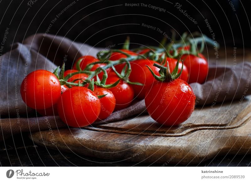Cherry tomatoes on a dark background close up Vegetable Vegetarian diet Diet Table Dark Fresh Bright Red Black cherry tomatoes cook cooking empty food health