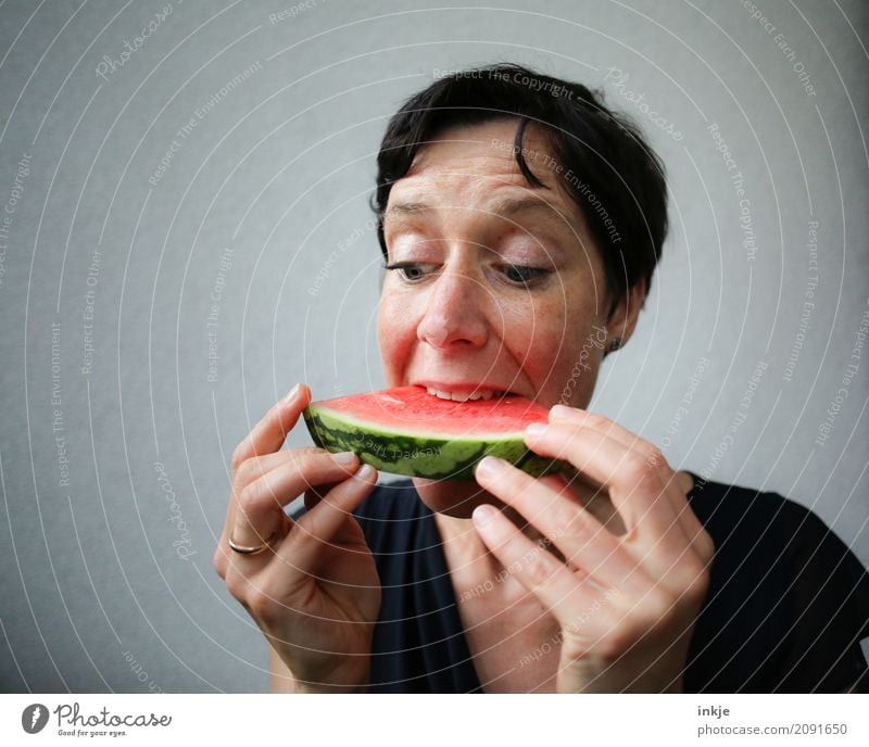 Not so young woman finally biting in watermelon Fruit Water melon Melon Woman Adults Life Face Hand 1 Human being 30 - 45 years Part Eating To hold on To enjoy