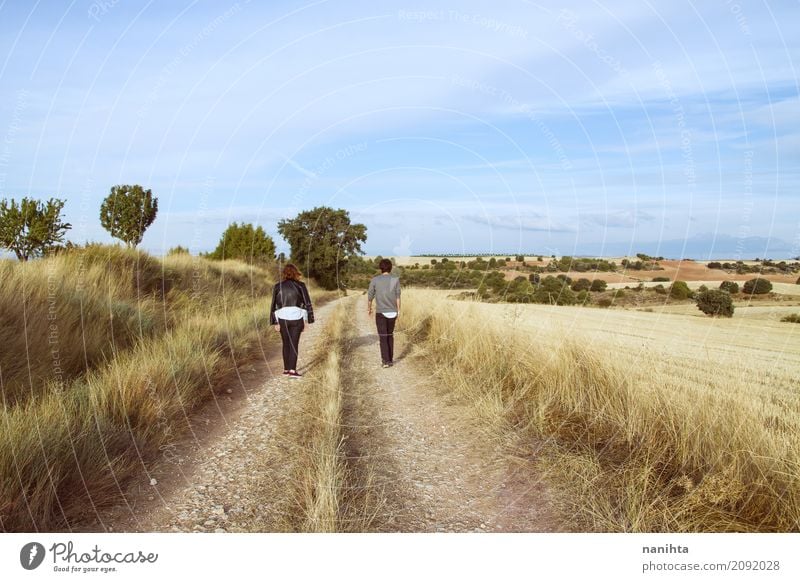 Young couple walking away on a rural path Lifestyle Vacation & Travel Adventure Human being Masculine Feminine Young woman Youth (Young adults) Young man
