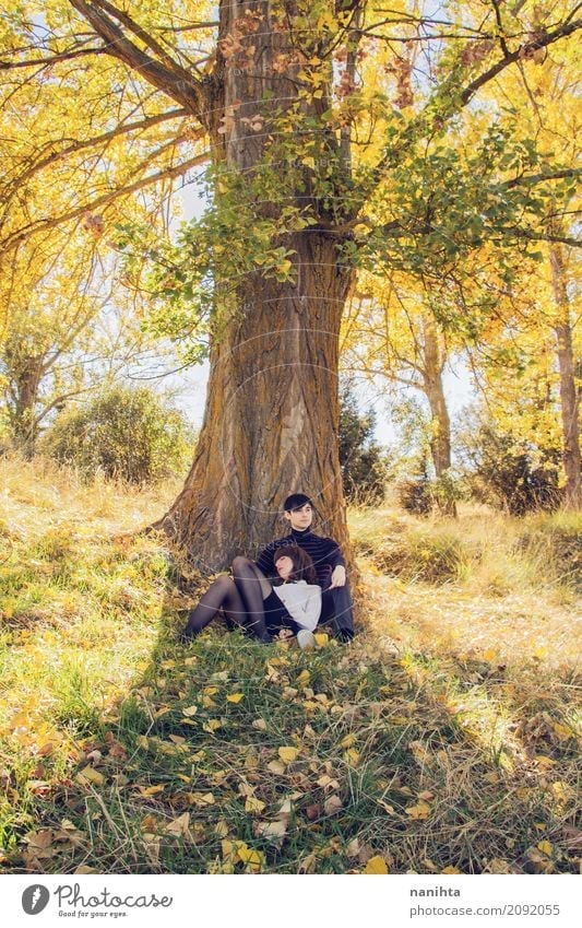 Young couple are sitting together under a tree Lifestyle Style Wellness Harmonious Well-being Relaxation Vacation & Travel Tourism Adventure Freedom Summer