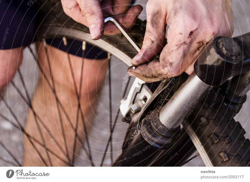 Young man fixing a bike Lifestyle Bicycle Cycling Wheel Sports Human being Masculine Youth (Young adults) Hand 1 18 - 30 years Adults Touch Old Dirty Dark