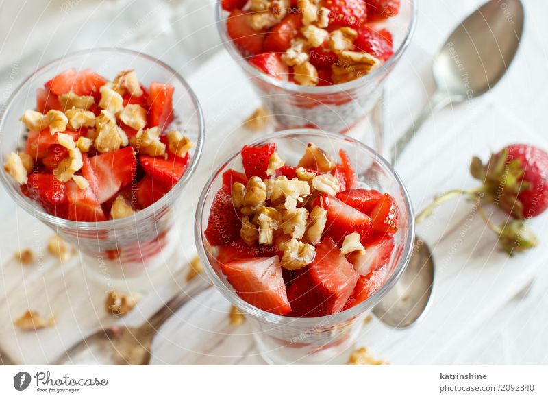 Chia pudding Strawberry parfait with greek yogurt and nuts Yoghurt Fruit Dessert Eating Breakfast Diet Glass Spoon Red White Berries Cereal chia Pudding seed