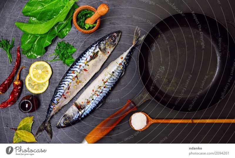 Two mackerels in spices Seafood Herbs and spices Nutrition Lunch Dinner Diet Pan Spoon Ocean Table Restaurant Gastronomy Nature Animal Wood Fresh Natural Green
