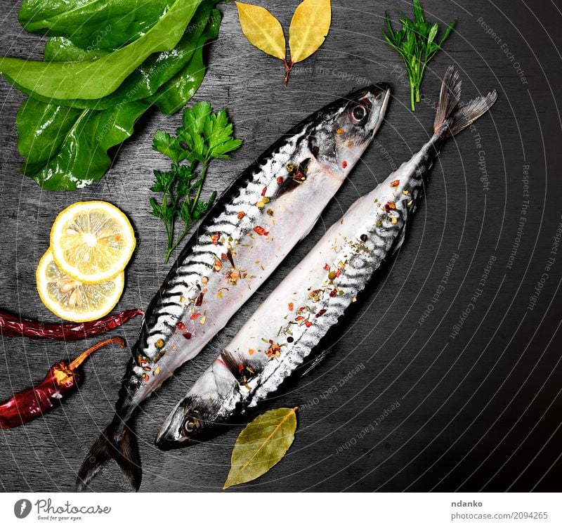 Two fresh mackerel in spices Seafood Herbs and spices Nutrition Lunch Dinner Diet Ocean Table Restaurant Gastronomy Nature Animal Wood Dark Fresh Naked Natural