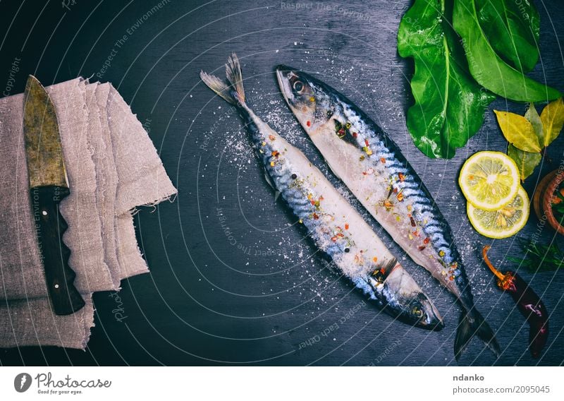 Two mackerels in spices Seafood Herbs and spices Nutrition Lunch Dinner Diet Knives Ocean Table Kitchen Restaurant Gastronomy Animal Wood Dark Fresh Natural