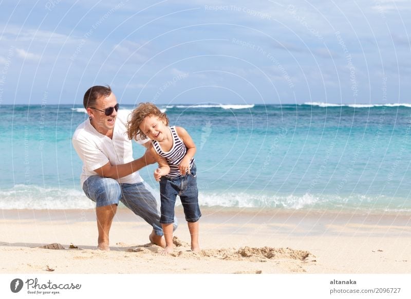 Happy father and son playing on the beach Lifestyle Joy Relaxation Leisure and hobbies Playing Vacation & Travel Trip Freedom Summer Sun Beach Ocean Child