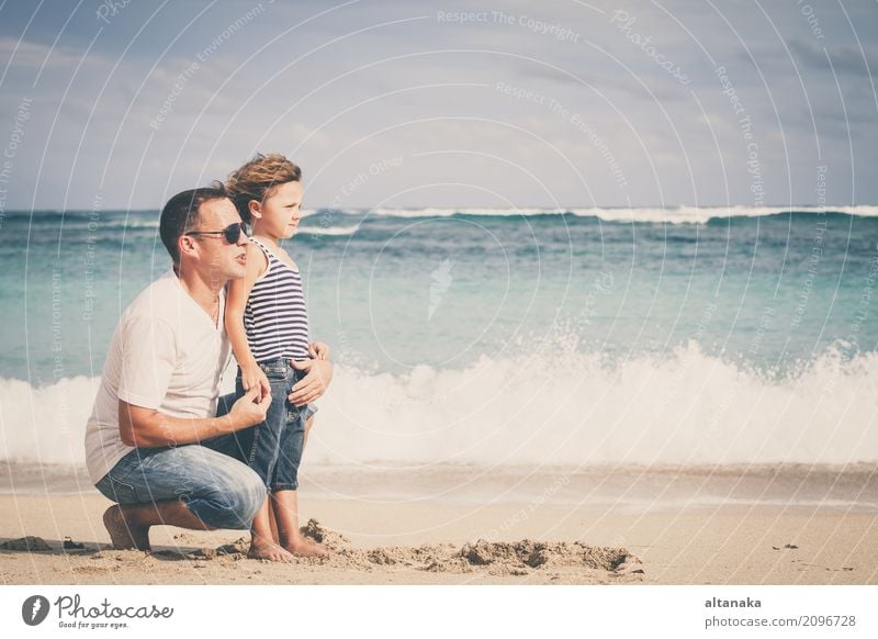 Happy father and son playing on the beach at the day time. Concept of friendly family. Lifestyle Joy Relaxation Leisure and hobbies Playing Vacation & Travel
