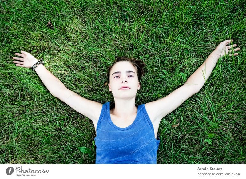 Teenager relaxed lying on her back on a meadow Lifestyle Joy Happy pretty Harmonious Well-being Contentment Senses Relaxation Calm Meditation Summer Human being