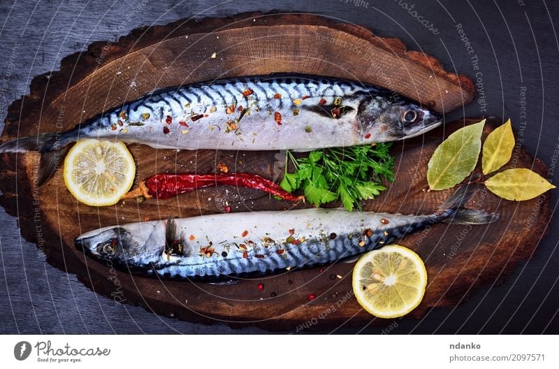 Mackerel in spices Seafood Herbs and spices Nutrition Lunch Dinner Diet Table Restaurant Gastronomy Nature Animal Wood Dark Fresh Natural Green Black Meal Lemon