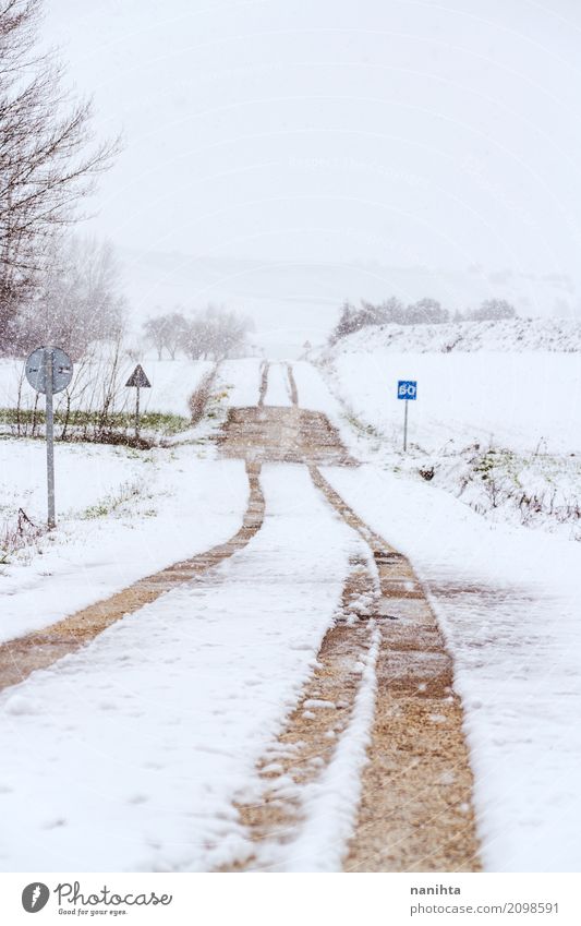 Snowy rural road at winter Environment Nature Landscape Air Sky Winter Climate Climate change Weather Bad weather Storm Snowfall Deserted Transport Road sign