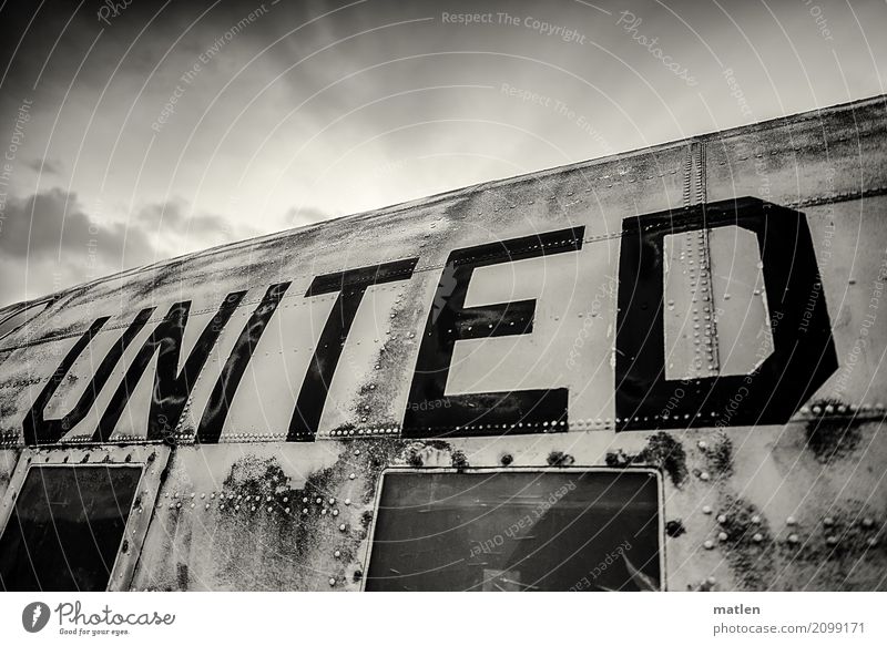 UNITED Means of transport Aviation Airplane Passenger plane Old Dark united Clouds Sky Wreck Window Navy Black & white photo Exterior shot Close-up Pattern