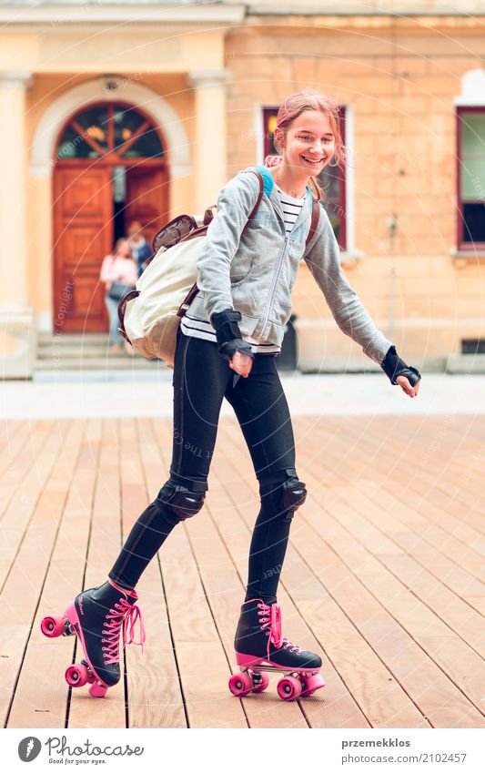 Young girl roller skating in a town spending time actively outdoors on summer day Lifestyle Joy Happy Relaxation Vacation & Travel Summer Sports Child