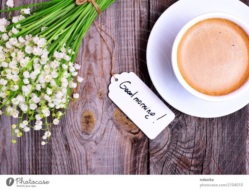 Cup of cappuccino and bouquet Breakfast To have a coffee Hot drink Coffee Espresso Mug Table Restaurant Flower Bouquet Wood Blossoming Fresh Good Above Retro