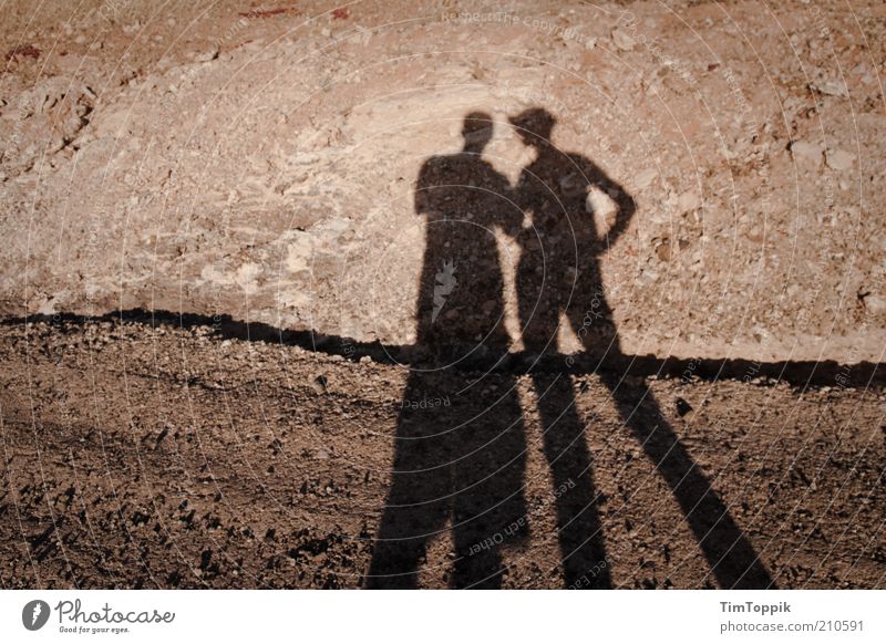 The other day on Mars. 2 Human being Lanes & trails Gloomy Shadow Shadow play Couple Sparse Desert Lanzarote Red Empty Stony Gravel path Exterior shot Together