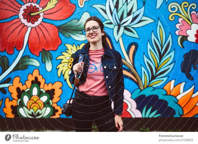 Young woman in front of colorful graffiti wall Feminine Youth (Young adults) Woman Adults 1 Human being Joie de vivre (Vitality) Mural painting Street art bleed