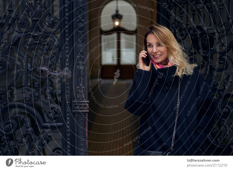 Woman standing in an ornate historic doorway Style Happy Winter House (Residential Structure) Business Telephone PDA Adults 1 Human being 30 - 45 years Coat