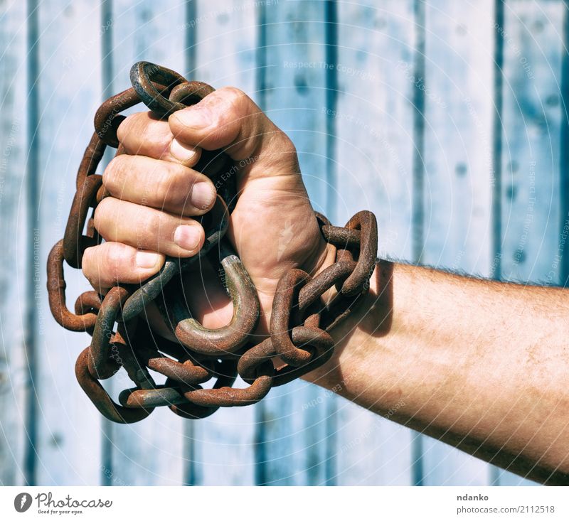 hand is wrapped in an iron chain Freedom Man Adults Hand Fingers Metal Dirty Blue Might Idea Independence link part Conceptual design slavery exploitation will