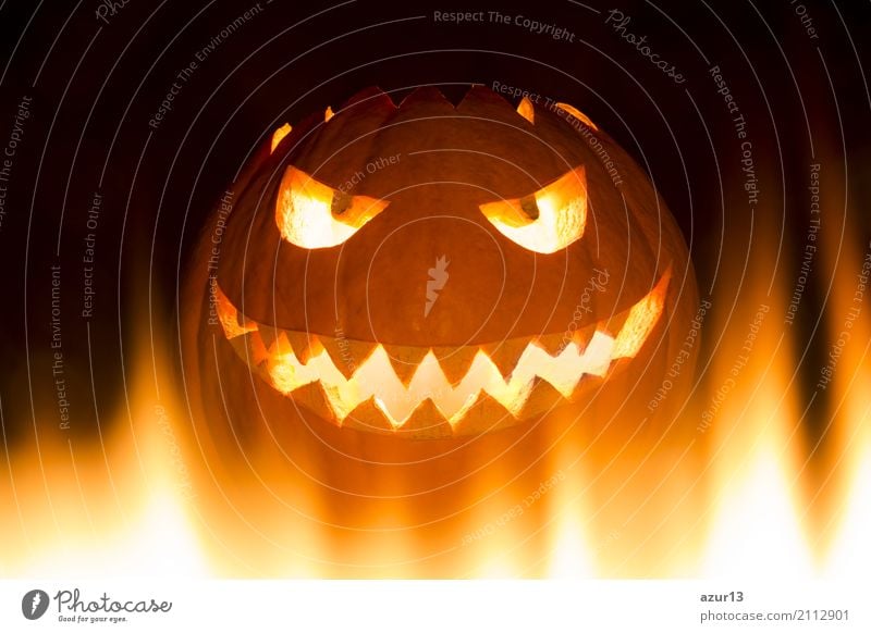 Creepy carved Halloween pumpkin burns in fire flames Vegetable Lifestyle Face Playing Handicraft Model-making Decoration Feasts & Celebrations Hallowe'en Eyes