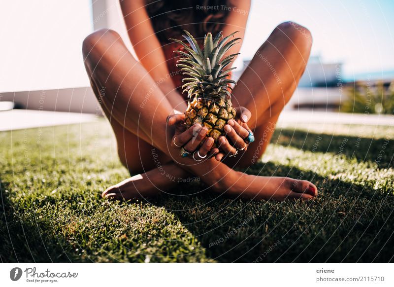 Woman in swimsuit sitting on grass holding pineapple Food Fruit Nutrition Lifestyle Joy Beautiful Leisure and hobbies Vacation & Travel Summer Garden