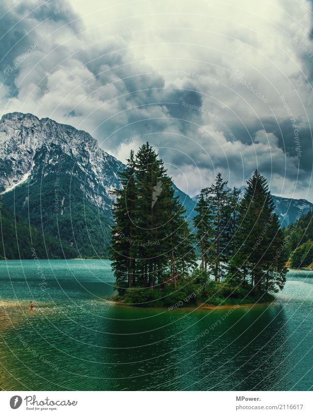 the lake of Ribles Environment Landscape Elements Clouds Storm clouds Bad weather Thunder and lightning Tree Forest Alps Mountain Peak Lakeside Esthetic Italy