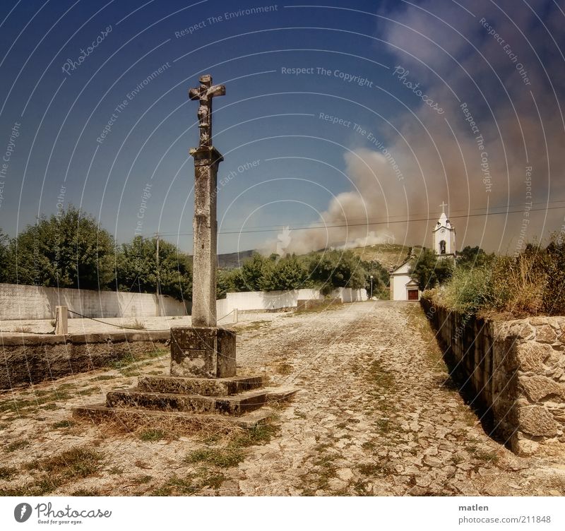 heaven and hell Beautiful weather Village Church Places Wall (barrier) Wall (building) Stone Blue Brown Dangerous Crucifix Smoke Fire Colour photo