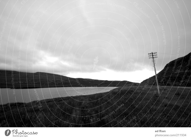 somber Nature Clouds Rain Grass Hill Lakeside Scotland Deserted Electricity pylon Dark Gloomy Stagnating Moody Black & white photo Copy Space top Cloud cover