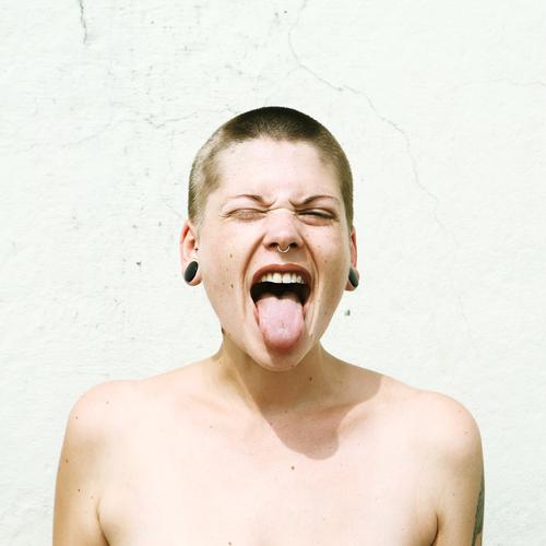 Young woman with short hair sticks out her tongue Lifestyle Style already Youth (Young adults) Face Tongue 18 - 30 years Adults Youth culture Subculture