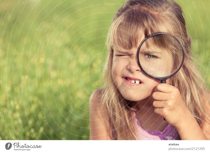 Happy little girl exploring nature with magnifying glass Lifestyle Joy Leisure and hobbies Playing Summer Garden Child School Human being Family & Relations