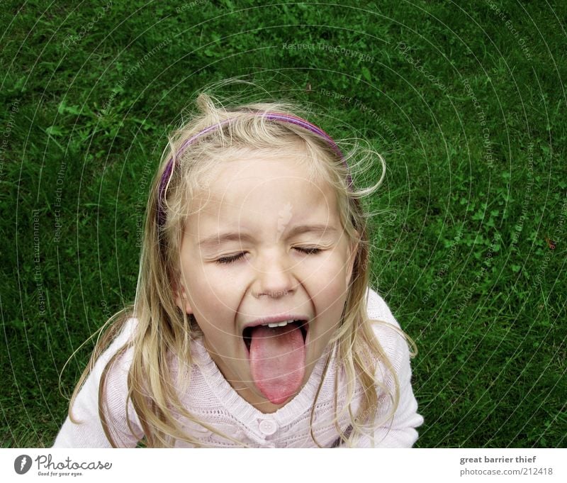 girl child tongue meadow Human being Child Girl Infancy Head Hair and hairstyles 1 3 - 8 years Scream Romp Sadness Cry Green Puzzle Grumble Meadow Wind Tongue