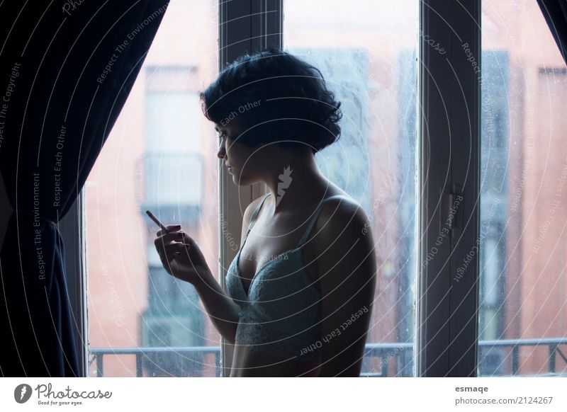 Girl smoking Lifestyle Elegant Style Window Feminine Young woman Youth (Young adults) Observe Think Smoking Sadness Eroticism Natural Curiosity Rebellious Blue