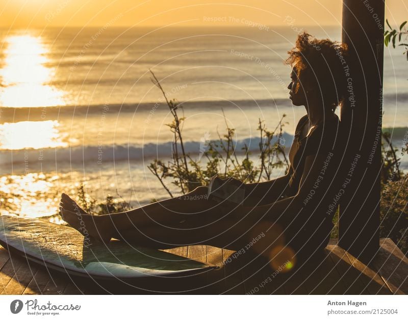 Surfer girl sitting next to surfboard on high cliff Feminine Young woman Youth (Young adults) 18 - 30 years Adults Breathe Discover Reading Dream Surfing