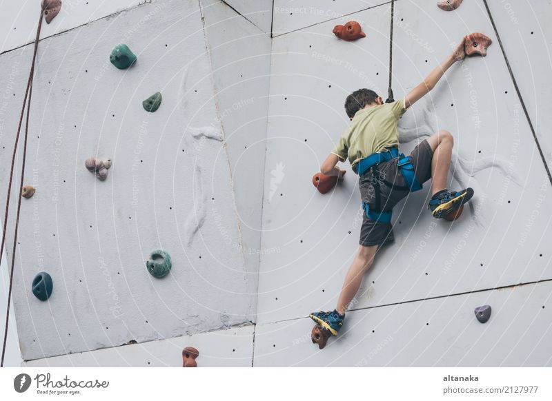 little boy climbing a rock wall outdoor. Concept of sport life. Joy Leisure and hobbies Playing Vacation & Travel Adventure Camping Entertainment Sports