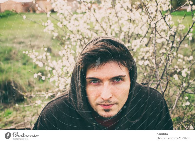 Young man posing with white flowers as background Lifestyle Human being Masculine Youth (Young adults) 1 18 - 30 years Adults Nature Plant Spring Climate