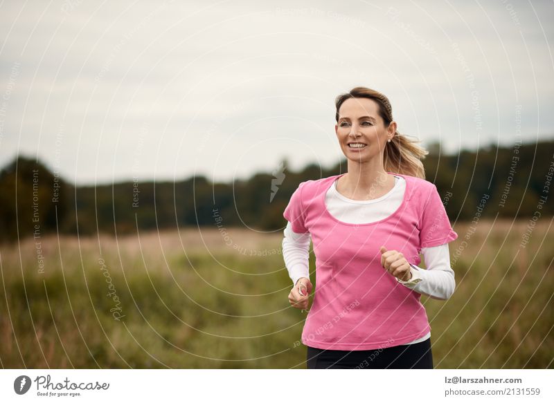 Cheerful woman running through field Lifestyle Face Summer Sports Jogging Woman Adults 1 Human being 30 - 45 years Nature Autumn Blonde Fitness Smiling cheerful