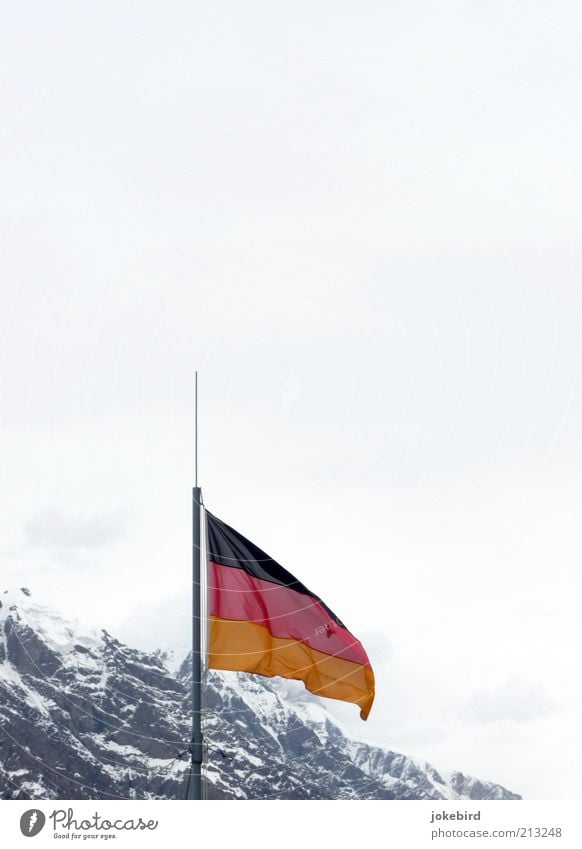 Germany is (mountain)abolishing itself? Sky Winter Snow Rock Alps Mountain Peak Snowcapped peak Flag Cold Ice Covered Clouds German Flag Wind White Kyrgyzstan