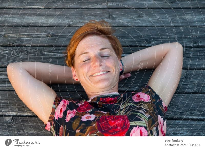 At the lake - young woman lying smiling in the evening sun on a wooden jetty Wellness Harmonious Well-being Contentment Relaxation Vacation & Travel Summer