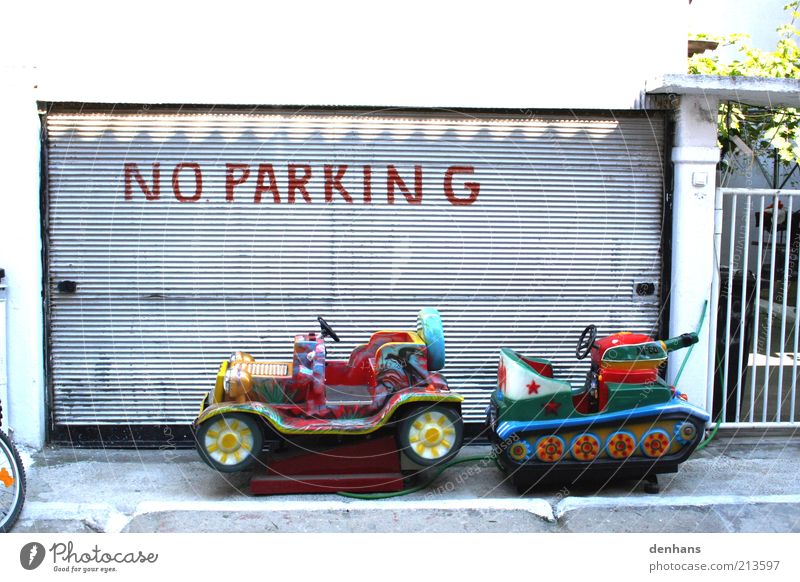 Not here! Children's game Facade Roller blind Motoring Street Road sign Car Signage Warning sign Playing Funny Multicoloured Colour photo Exterior shot Deserted