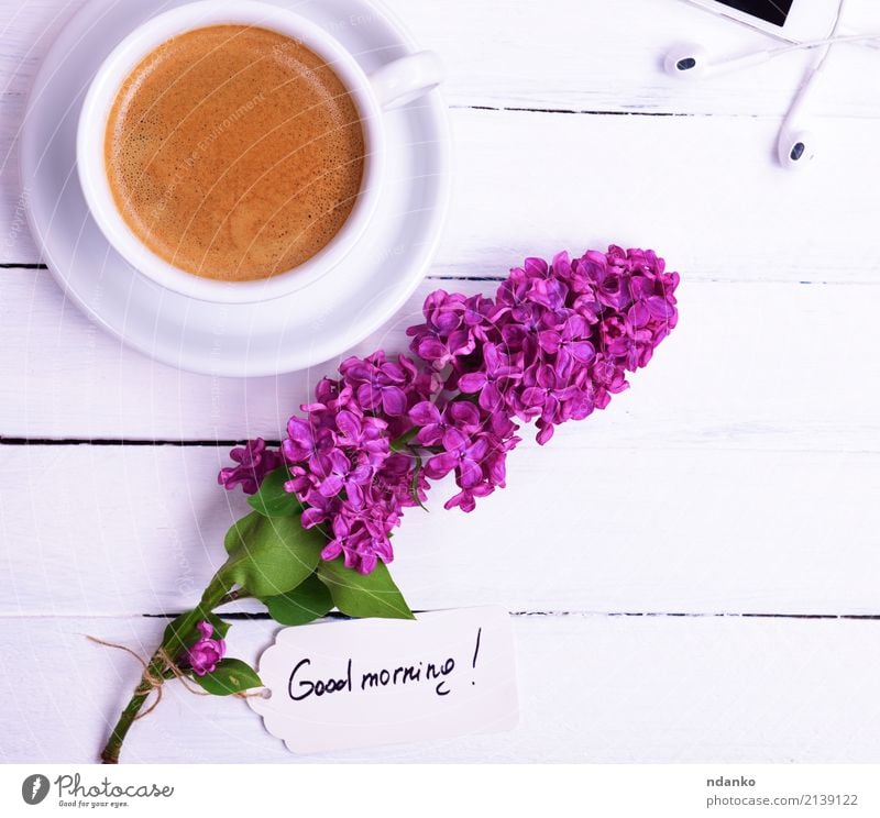 Black coffee in a white cup Breakfast To have a coffee Hot drink Coffee Espresso Mug Telephone PDA Flower Paper Wood Blossoming Eating White Bud Lilac Purple