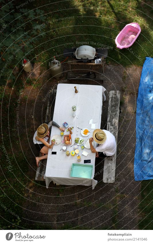 Breakfast in the garden - view from above of two people / man and woman sitting at a table, eating and talking to each other Nutrition Eating Happy Couple
