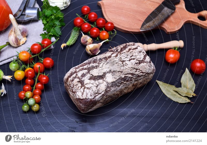 loaf of fresh rye bread Food Vegetable Bread Eating Knives Wood Fresh Delicious Brown Red Black Rye Tomato background ripe Garlic knife appetizing floury board