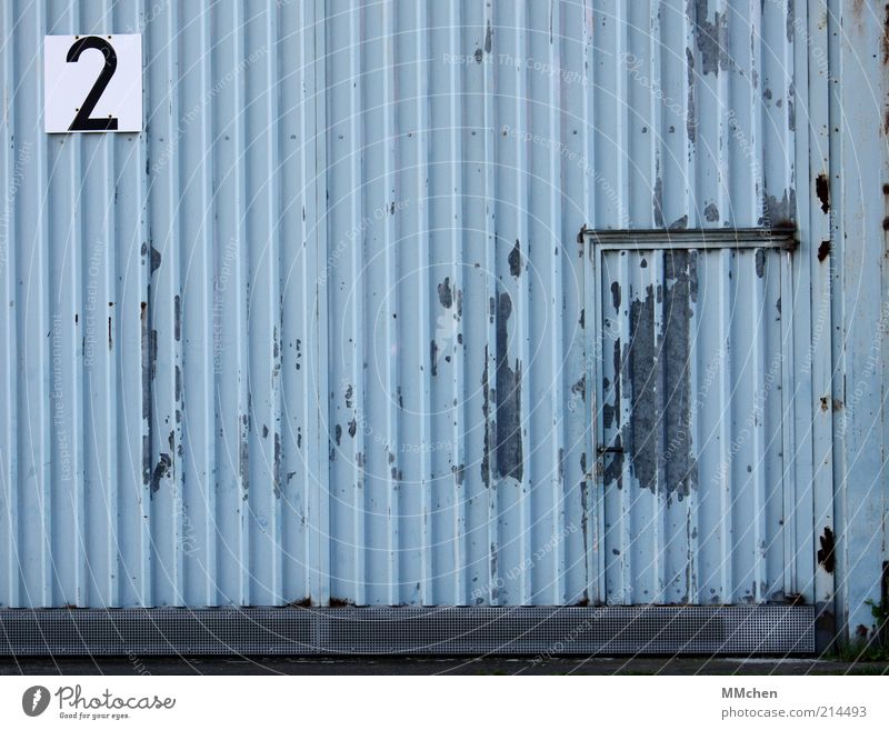 2 Building Blue Hall Tin Door Entrance Signs and labeling signage Digits and numbers Gray Hangar Colour photo Exterior shot Deserted Copy Space left