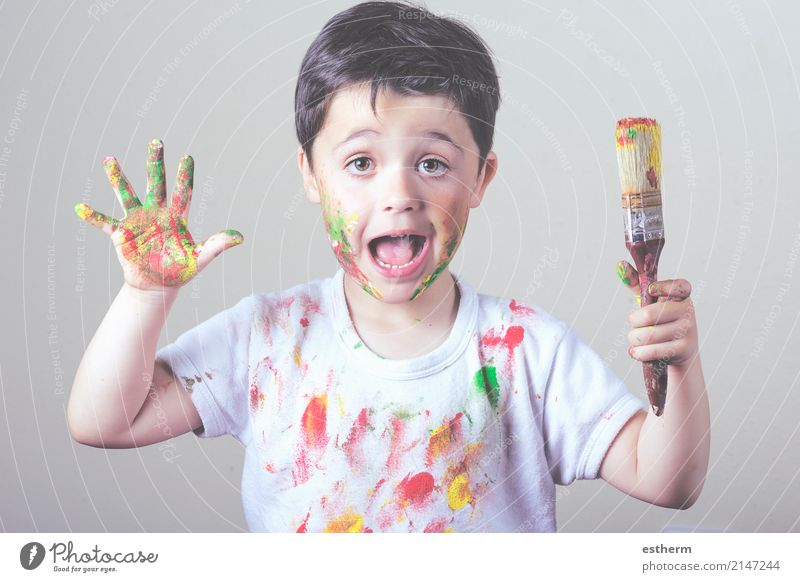 boy with painted face and T-shirt painting Lifestyle Joy Children's game Education Kindergarten School Human being Masculine Toddler Infancy 1 3 - 8 years