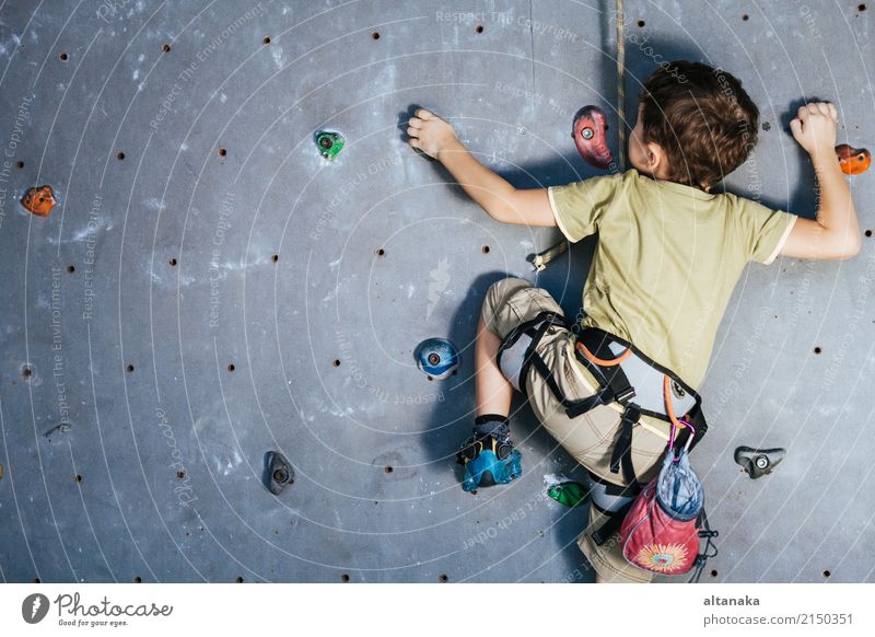 little boy climbing a rock wall indoor. Concept of sport life. Joy Leisure and hobbies Playing Vacation & Travel Adventure Camping Entertainment Sports Climbing