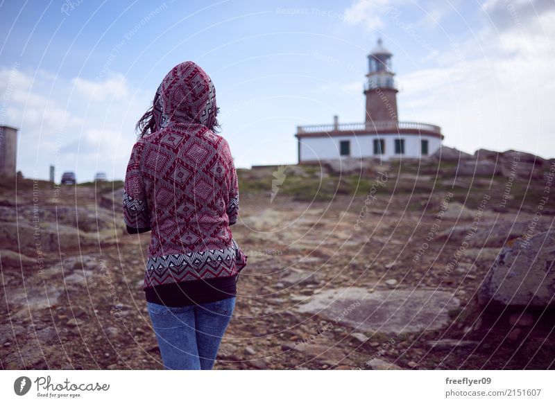 Woman walking towards a lighthouse Lifestyle Vacation & Travel Tourism Trip Adventure Sightseeing Expedition Winter Hiking Human being Feminine Young woman