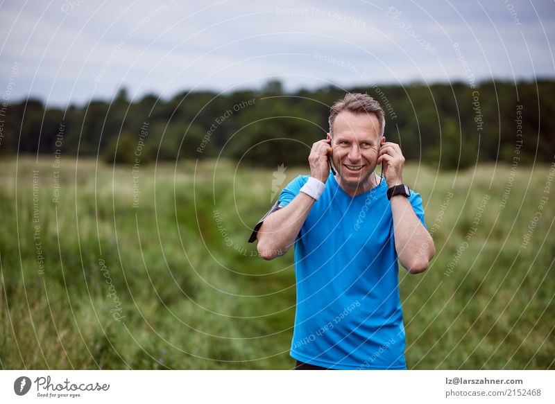 Man listening to music while walking outdoors Happy Face Relaxation Entertainment Music Telephone Technology Adults Landscape Beard Listening Smiling Athletic