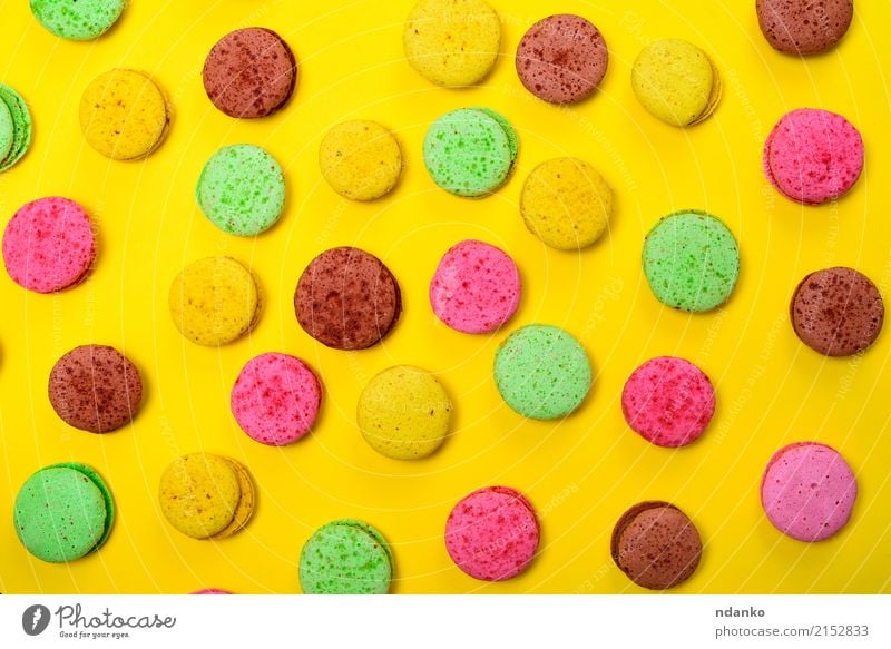 Colorful pastry macarons Food Dessert Candy Gastronomy Eating Bright Brown Multicoloured Yellow Green Pink Tradition colorful background Macaron sweet cake