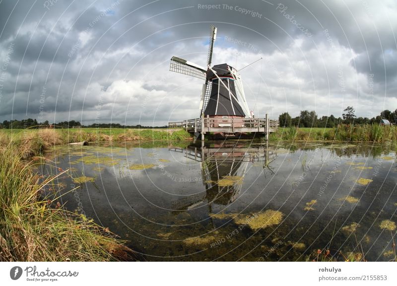 windmill reflected in lake water on sunny day Summer Sun Culture Landscape Sky Clouds Meadow Pond Lake Building Architecture Blue Green Windmill star sunshine